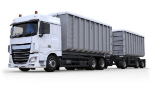 Large white truck with separate trailer, for transportation of agricultural and building bulk materials and products.